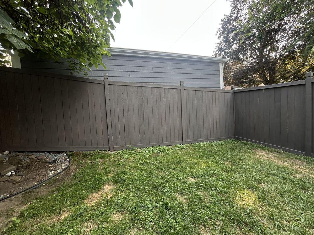 A privacy fence we cleaned, stained and sealed, including the post caps and rails