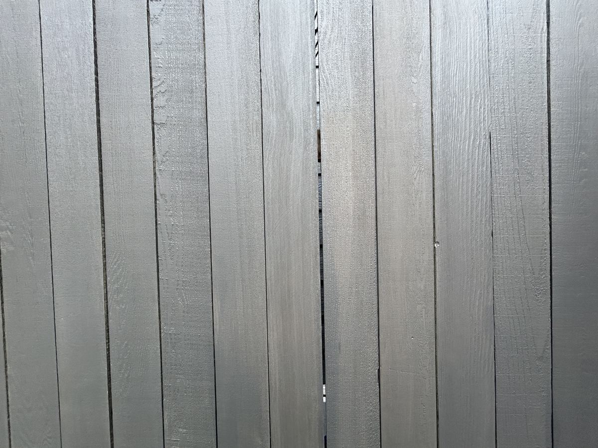 The same cedar boards after cleaning and a solid grey stain, colour even across every board
