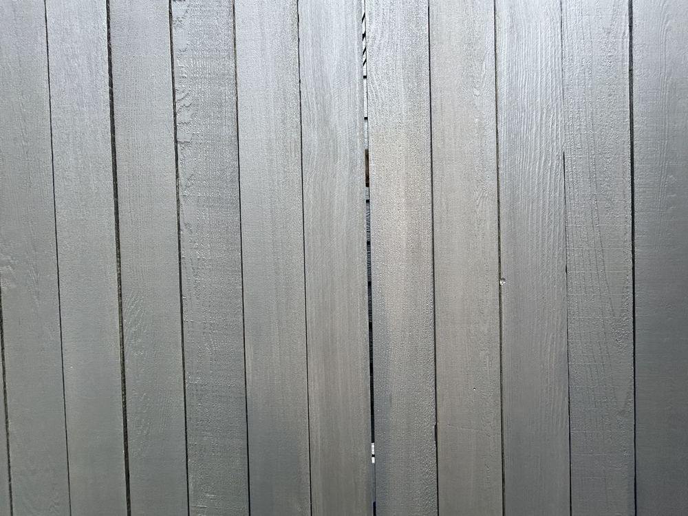 Cedar fence boards after cleaning and a solid grey stain, colour even across every board